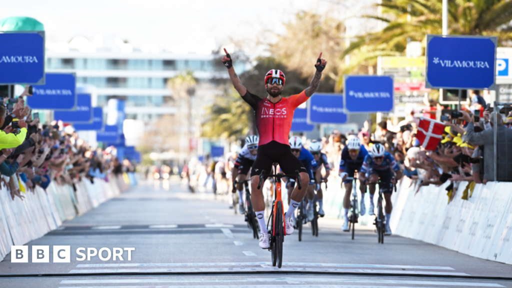 Filippo Ganna raises his arms in celebration after winning the first stage of the Volta ao Algarve - before the stage was cancelled