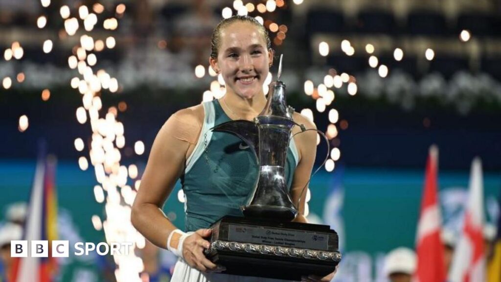 Mirra Andreeva celebrates with the Dubai Tennis Championships trophy