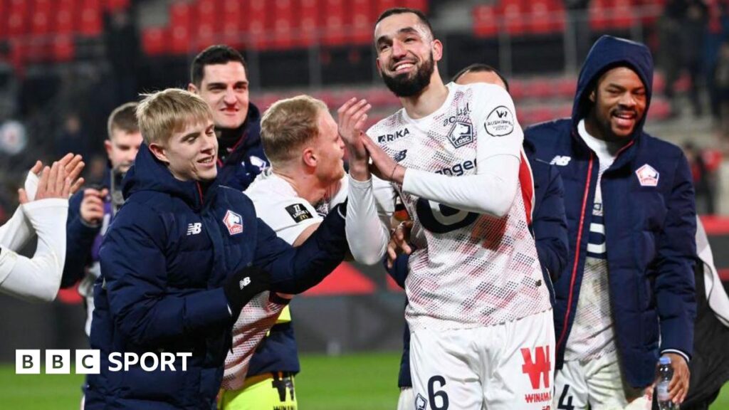 A smiling Nabil Bentaleb celebrating with his Lille team-mates at full time.