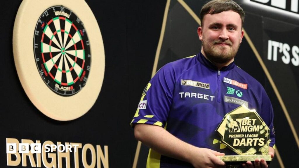 Luke Littler with the trophy after winning in Brighton