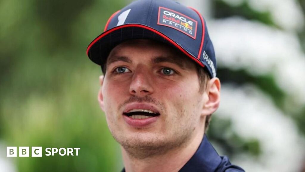 A close-up image of Max Verstappen wearing a Red Bull Racing cap